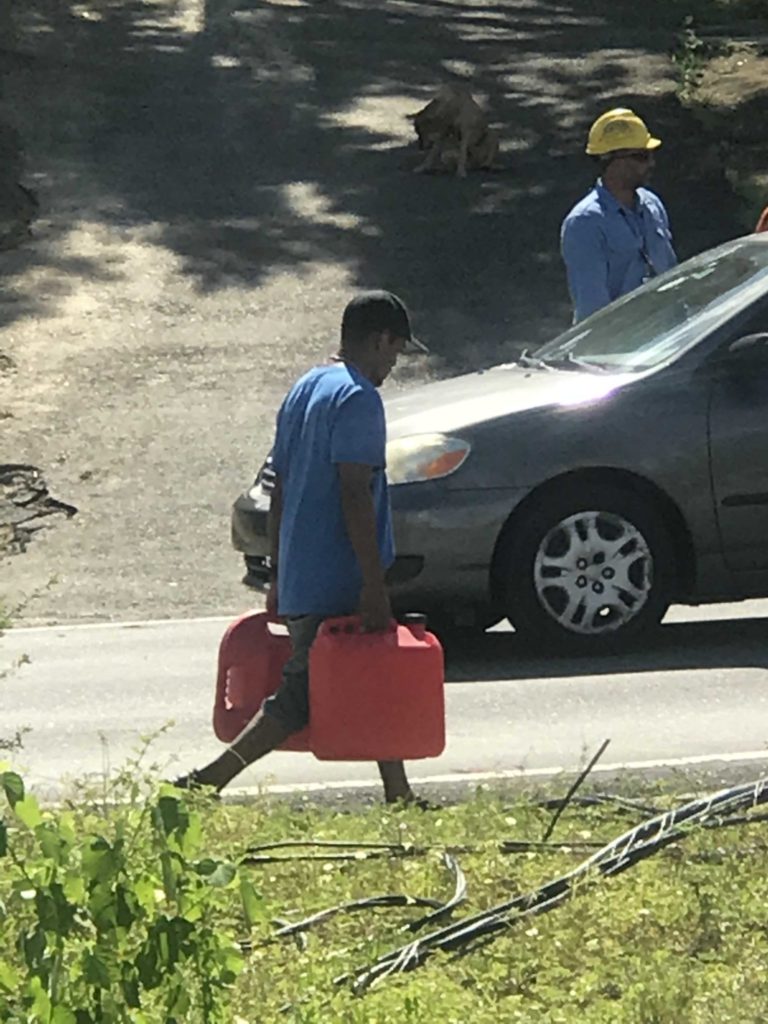 Man carrying gas cans