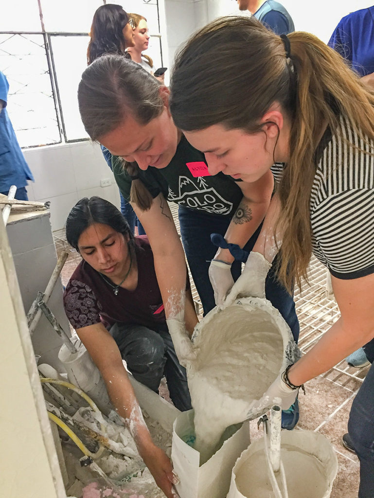 CSU mechanical engineering student Alyssa Shepherd and CSU biomedical and mechanical engineering student Leslie DeLay, both standing, create a mold for a prosthetic device with help from a local ROMP volunteer. Photo courtesy Ellen Brennan-Pierce