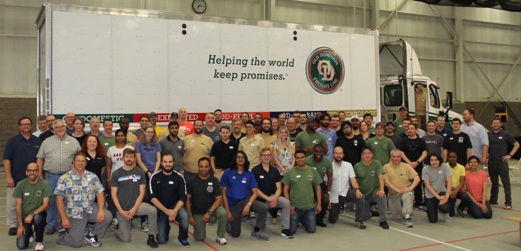CyberTruck Challenge 2019 participants stand in front of a semi-trailer truck (photo taken Summer 2019).