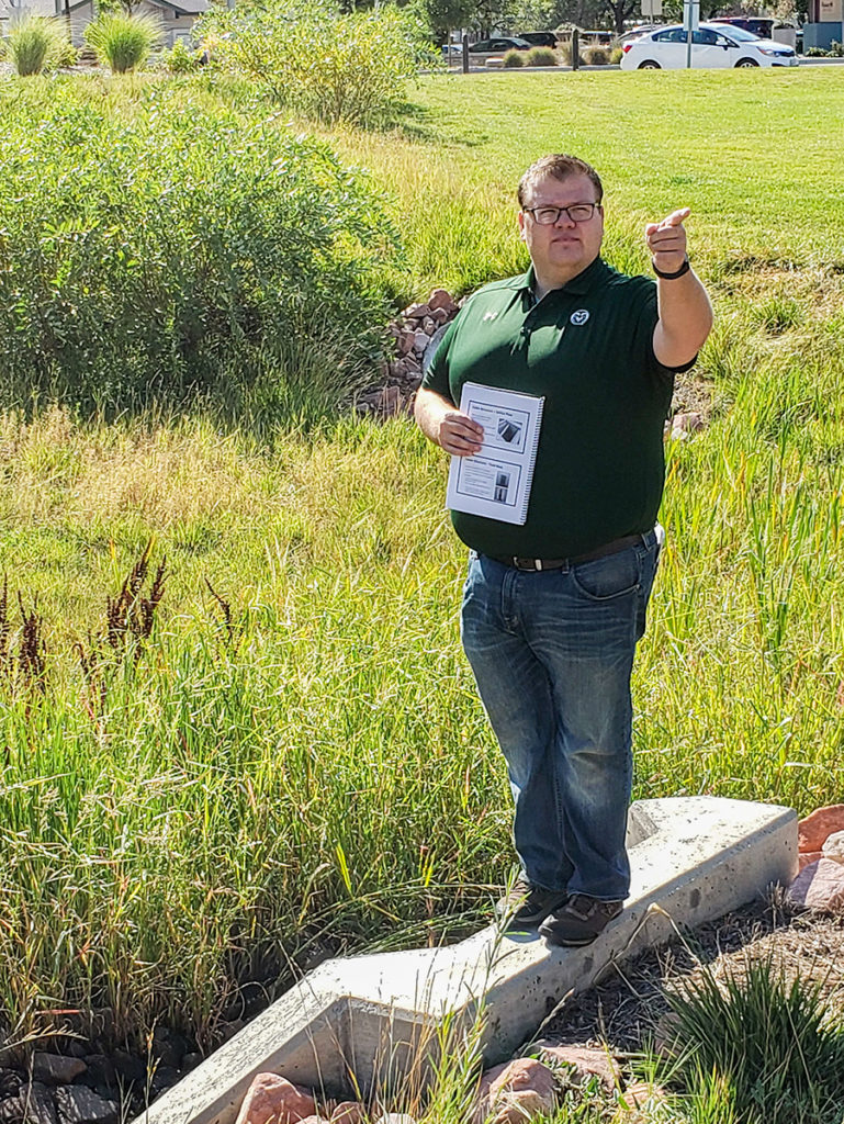 Colorado Stormwater Center director Tyler Dell showing the stormwater features near the CSU Health and Medical Center, September 2019.