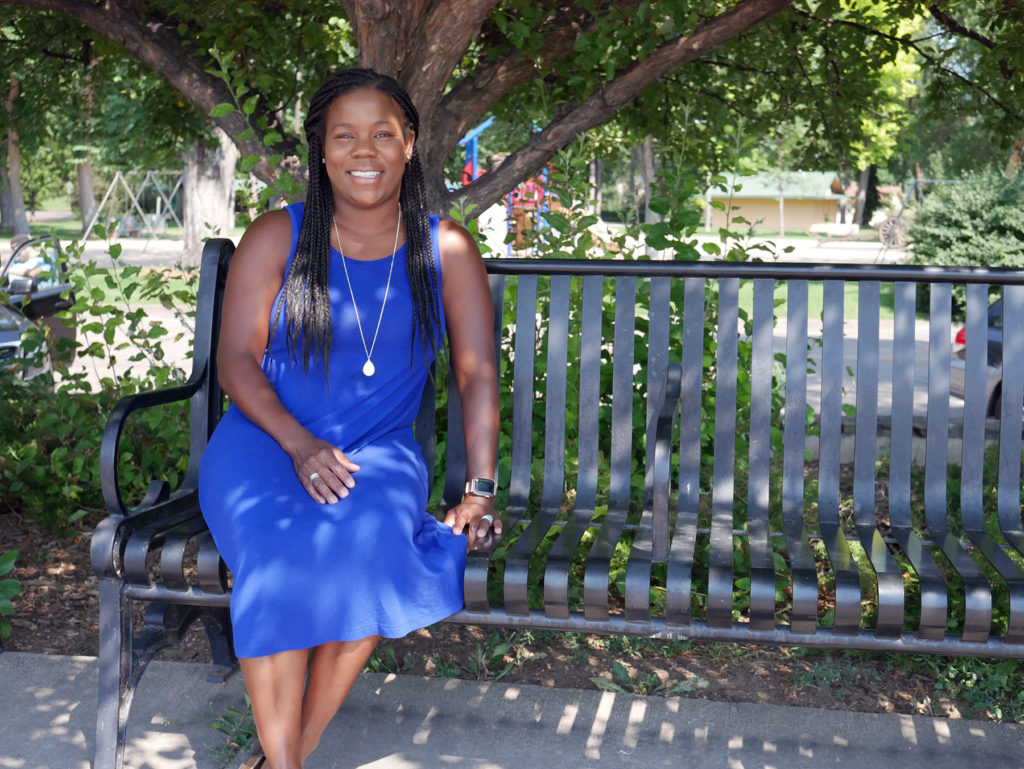 Melissa Burt, Assistant Dean for Diversity and Inclusion, sitting on a bench.