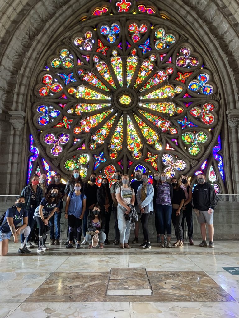 2021 CSU BME Ecuador Project; CSU Group poses for a photo while sightseeing, in front of the Stained Glass Window At Basilica