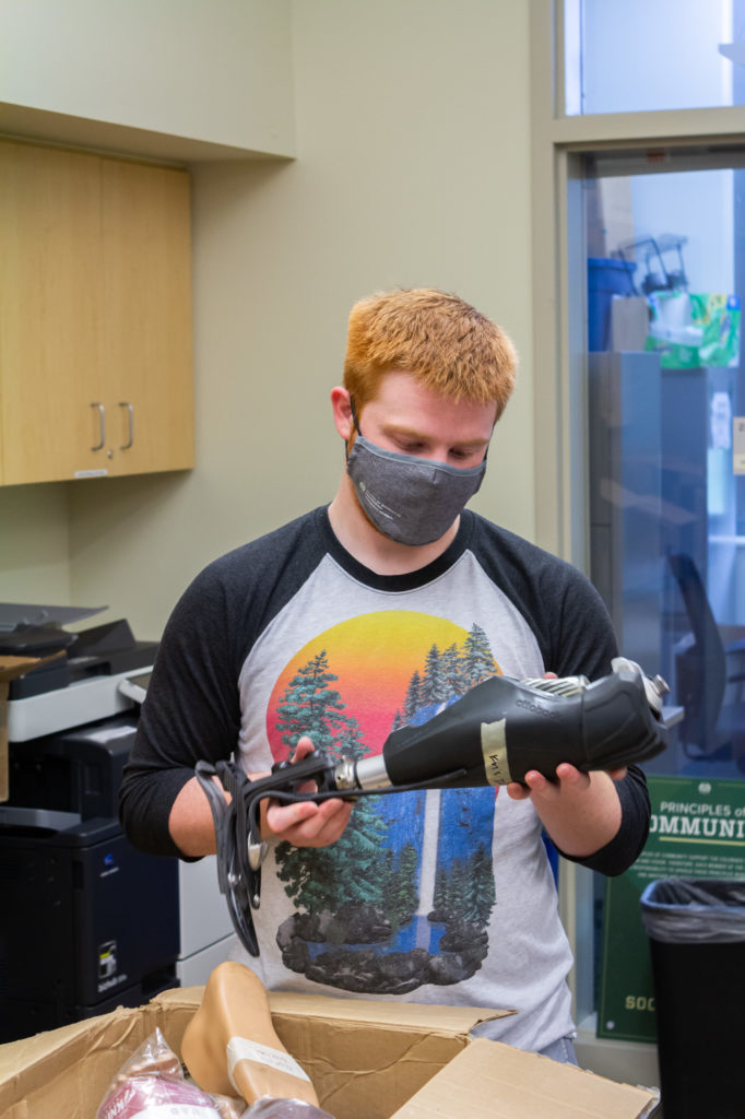 SBME student Matt Ahern examines prosthetic components to be personally delivered by the CSU group to ROMP in Ecuador, August 2021