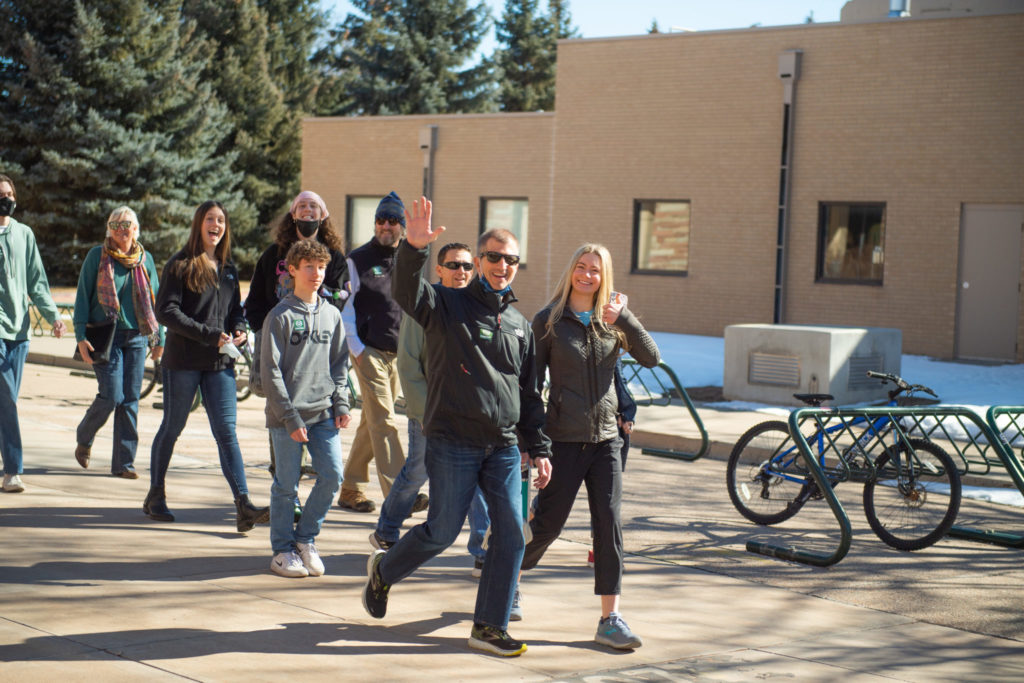 Visitors wave as they walk between buildings on the CSU campus