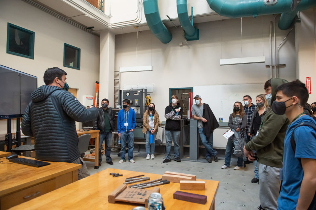 Candid photo of a student leading a tour in an engineering teaching laboratory