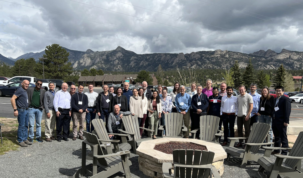 Participants in the Sustainable Agricultural Water Workshop pose for a group photo with the Rocky Mountains in the background.