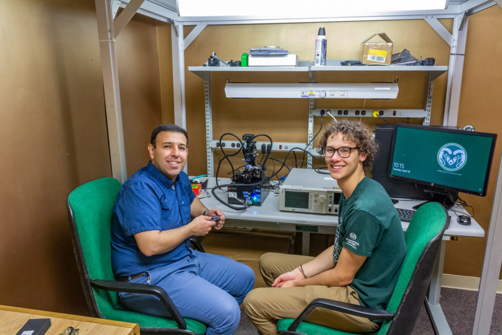 Mahdi Nikdast working with a Scott Undergradute Research Experience student in the laboratory.