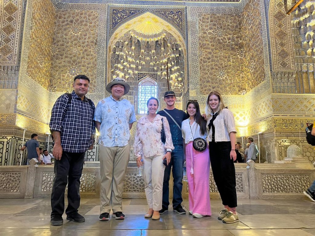 The CSU team in Uzbekistan standing in a cathedral: Ketul Popat, DaeSeok Chai, Pinar Omur-Ozbek, David Kulish, Mayca Saavedra and Sofia Zook.