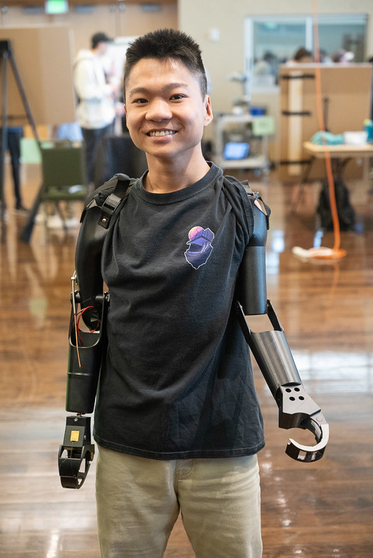 A picture of Jian Cohen, business student, testing out prosthetic limbs inside the LSC ballroom, April 24, 2023 at E-Days. (Credit: John Eisele/CSU)