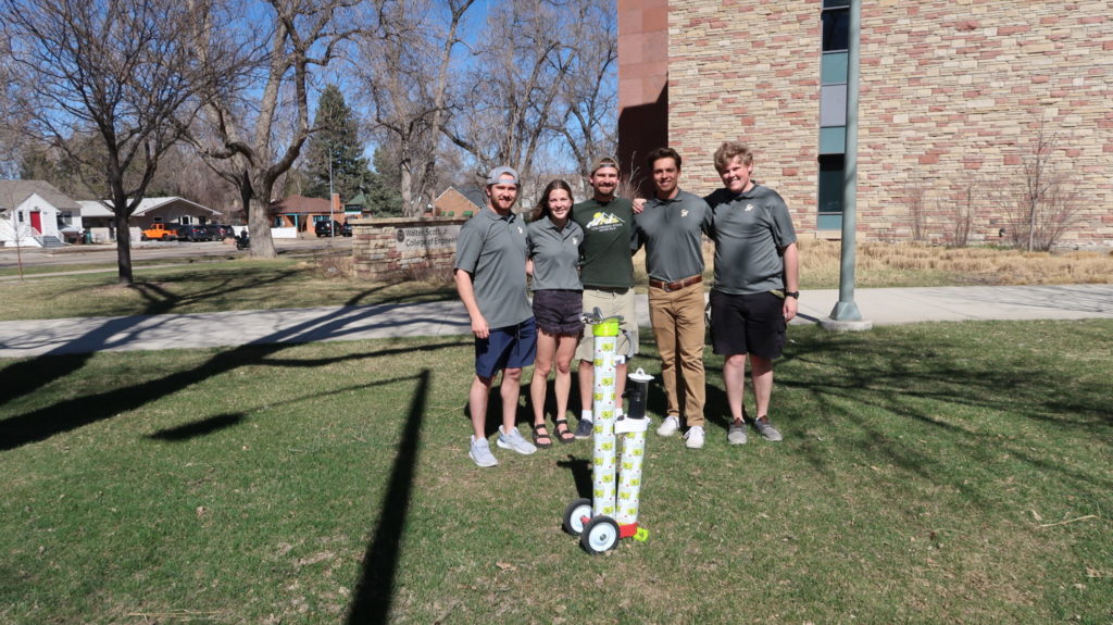 Members of the Course Rover team pose outside the Scott Bioengineering Building with an example of their 3D-printed golf bag.