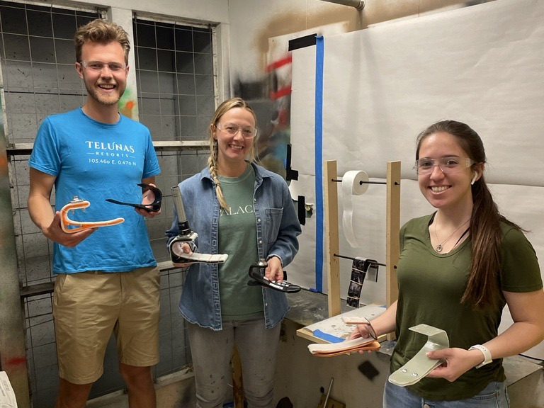 Members of Project Pitter Patter pose with prototypes of their prosthetic feet.