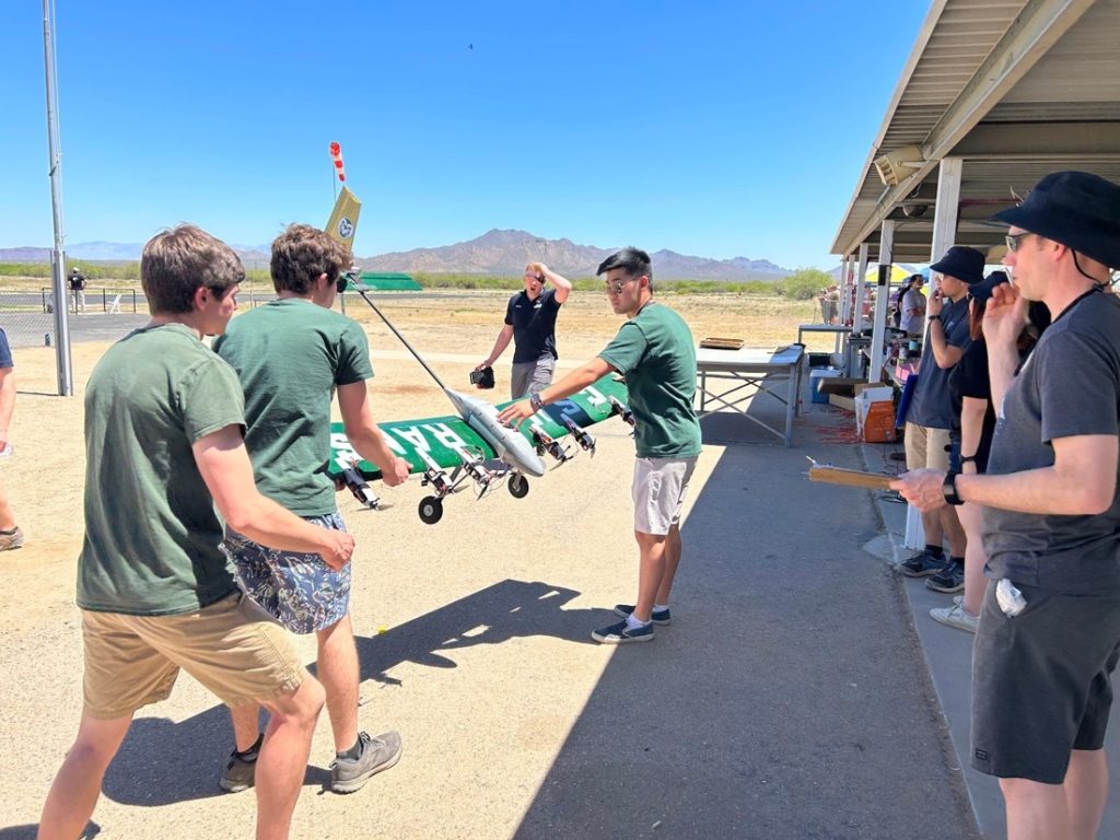 Bryan Slaughter (treasurer), Spencer Teeter (design lead) and Daniel Zhou (president), presenting the aircraft to DBF judges for technical inspection.