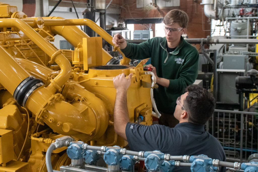 CSU student researchers work on a very large Caterpillar natural gas engine