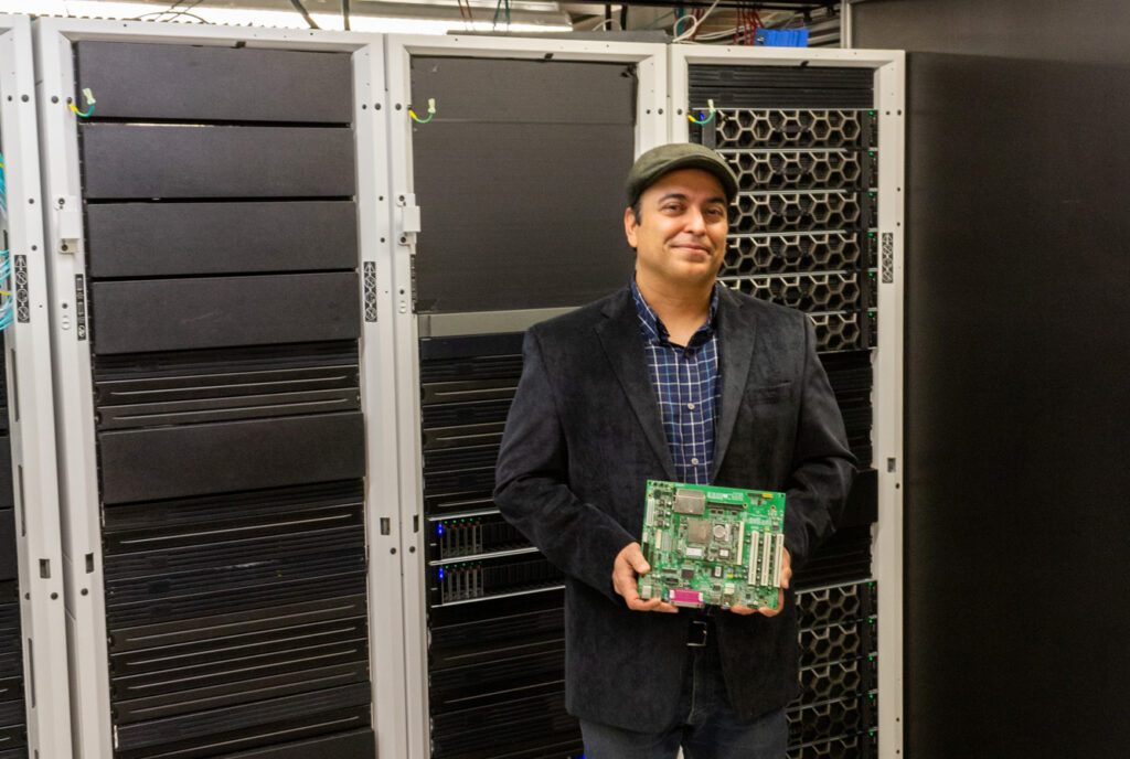 Electrical and Computer Engineering Professor Sudeep Pasricha stands in a Colorado State University data center.