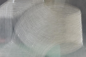 A close-up image of a completed scaffold. Visually, it resembles something like brushed stainless steel, with overlapping curved marks on a grey background.