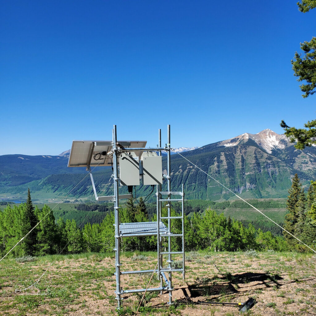 Sampling equipment bolted to a scaffold and secured with tensioned guy wires. In the background, a scene of summer in the high Rockies of central Colorado. Photo credit: Ezra Levin