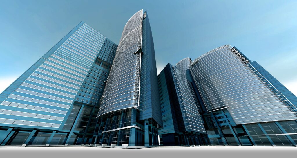 A low-angle photo showing a cluster of tall, modern buildings with glass exteriors.