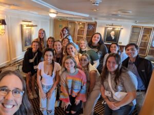 Johnson (in lower left corner) snaps a selfie with the students in her classroom aboard the ship during Semester at Sea.