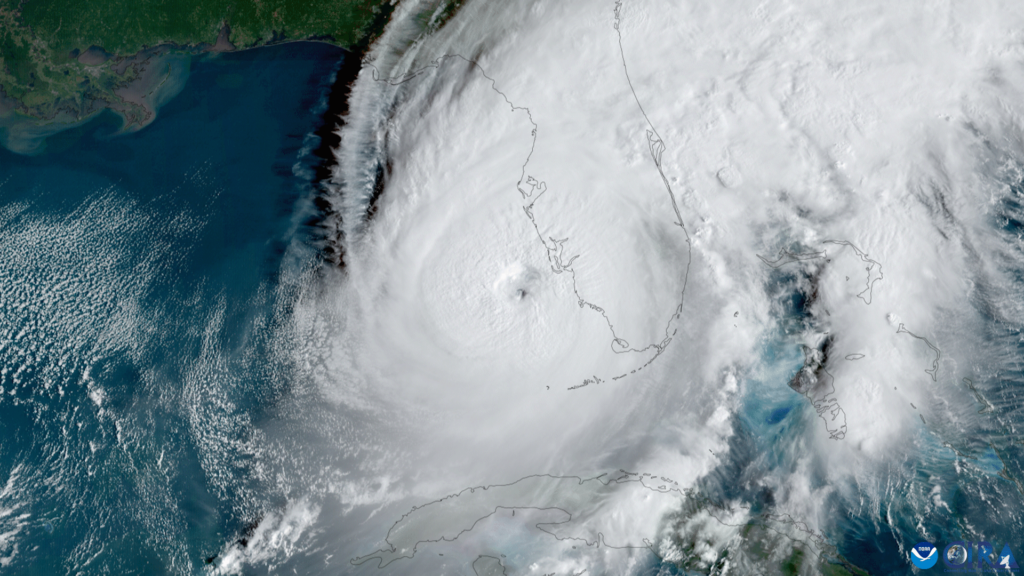 Satellite photo showing a hurricane with a clearly defined eyewall. The outline of the state of Florida and other map features have been added.